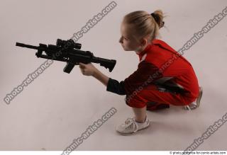 DENISA KNEELING POSE WITH GUN